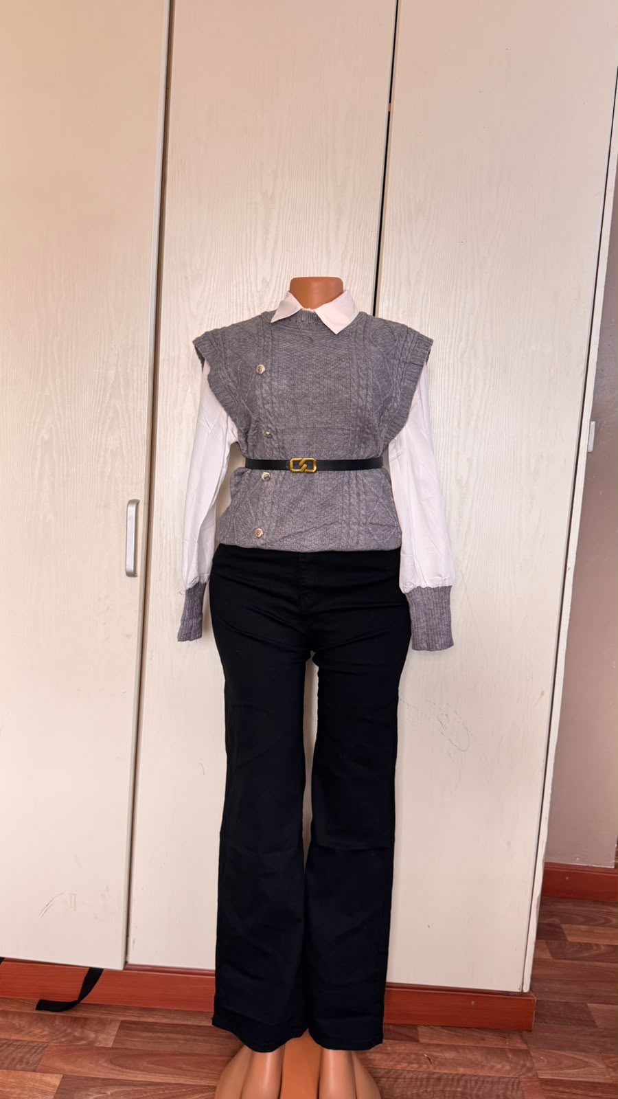Grey layered knit and trouser outfit displayed on a mannequin