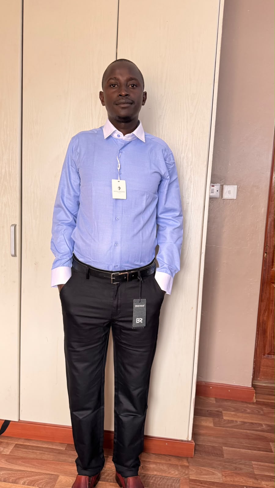 Man wearing a blue shirt and black trousers